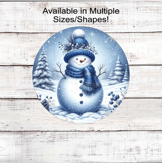 An adorable Snowman wearing a scarf in a snowy woodland setting.