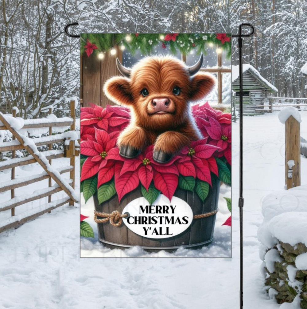 A beautiful brown Baby Highland Cow with poinsettia flowers