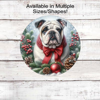 A grey, tan and white English Bulldog with in festive Winter setting and a red bow around his neck.