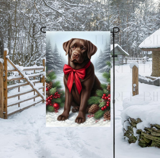 A beautiful chocolate Labrador Retriever in a Winter setting wearing a red bow.