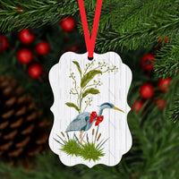 A beautiful Christmas ornament with a Blue Heron wearing a festive red bow.