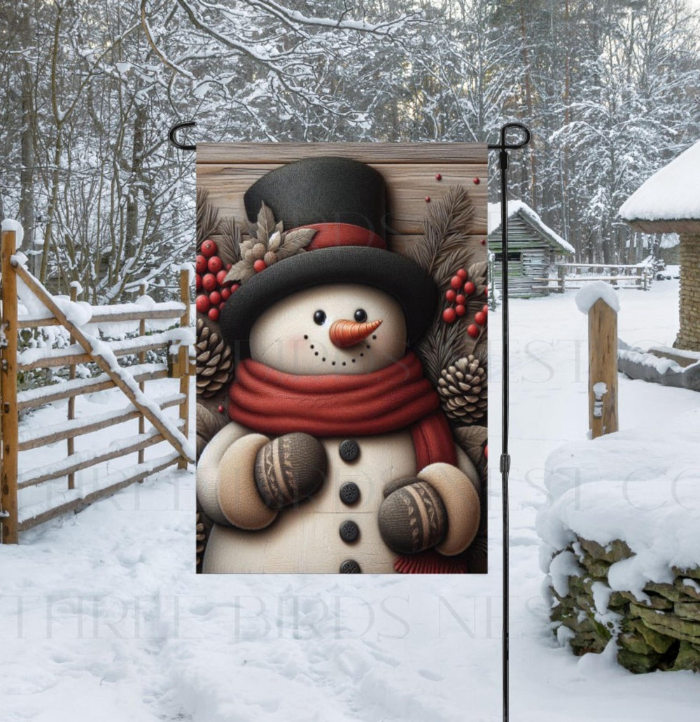 An adorable Snowman Garden Flag surrounded by pinecones, branches and berries on a rustic wood background.