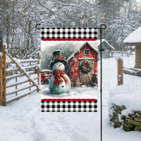 An adorable Snowman Garden Flag with a rustic wood barn and an old red truck in the background.