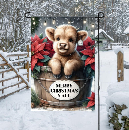 A beautiful tan Baby Highland Cow with poinsettia flowers