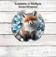 
              A beautiful baby Fox in a winter setting with blue and white poinsettias.
            