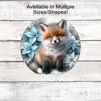 A beautiful baby Fox in a winter setting with blue and white poinsettias.