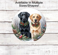 
              A black Labrador Retriever and a yellow Labrador Retriever dogs in Christmas collars in a winter woodland setting
            