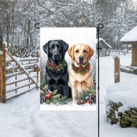 A black Labrador Retriever dog and a yellow Labrador Retriever dog in a Winter setting with festive collars on.