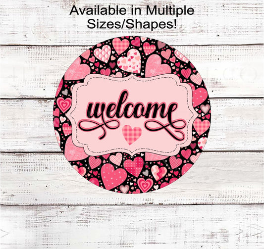 A Valentines Day Welcome sign made up of patchwork quilts hearts on a black background