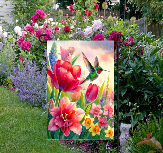 A beautiful Garden Flag with brightly colored flowers and Hummingbird.