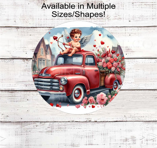 An adorable Cupid Cherub Angel on an old red pickup truck surrounded by Valetines florals.