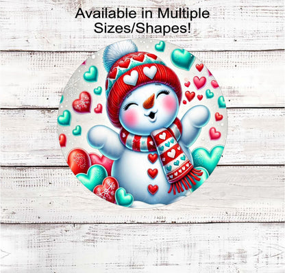 This adorable Snowman is blowing kisses surrounded by red, pink and turquoise hearts is ready to be your Valentine!