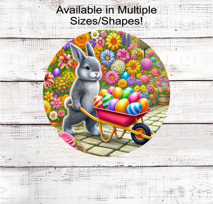 An adorable Easter Bunny with a wheelbarrow full of Easter Eggs surrounded by Spring Flowers.