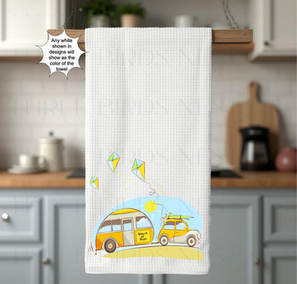 An adorable car towing a camper that says &quot;Beach or Bust&quot; with bright colors and cute kites.