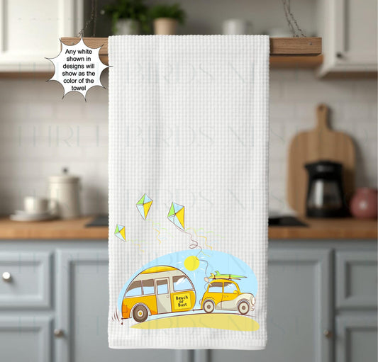 An adorable car towing a camper that says &quot;Beach or Bust&quot; with bright colors and cute kites.
