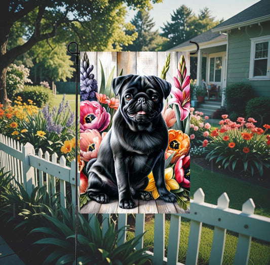 A beautiful black Pug dog surrounded by gorgeous flowers.