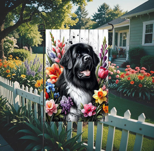 A beautiful Landseer Newfoundland dog surrounded by gorgeous flowers.