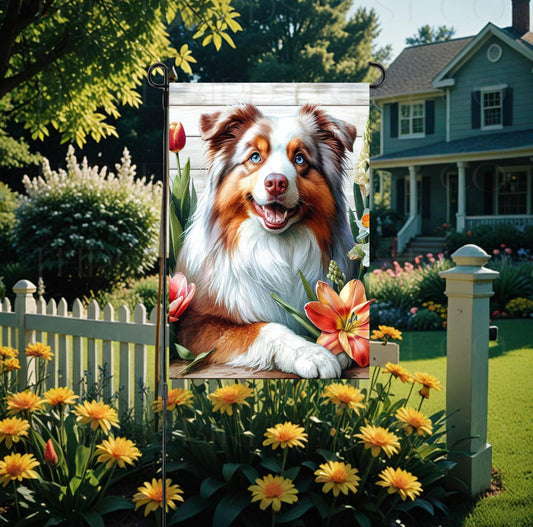 A beautiful Australian Shepherd dog surrounded by gorgeous flowers.