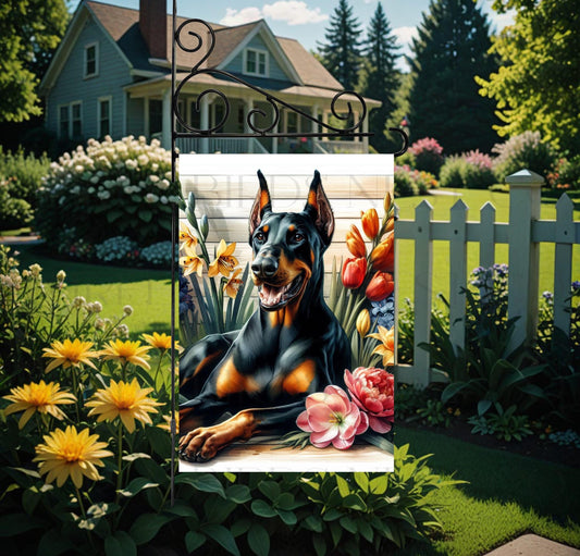 A beautiful black Doberman Pinscher dog surrounded by gorgeous flowers.