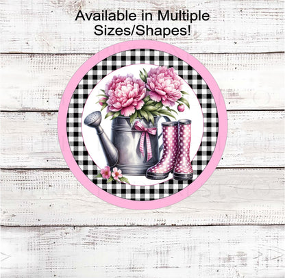 A beautiful watering can with pink Peonies and pink polka dot rain boots.