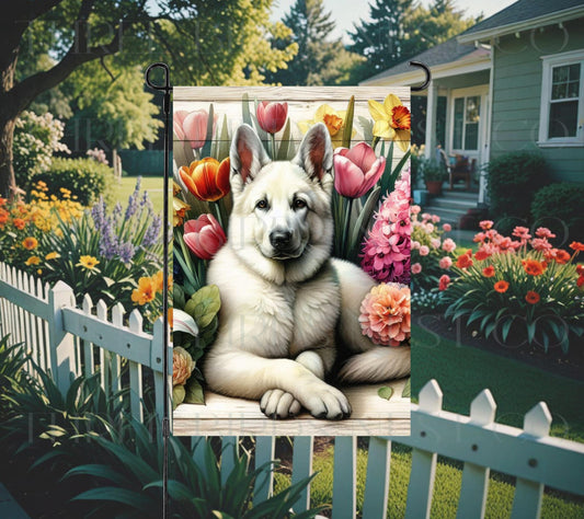 A beautiful white German Shepherd dog surrounded by gorgeous flowers.