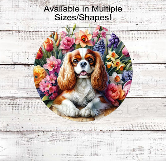 A beautiful Cavalier King Charles Spaniel dog surrounded by beautiful Spring flowers
