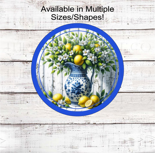 A beautiful Chinoiserie vase full of Lemon branches with fresh lemons and flowers.