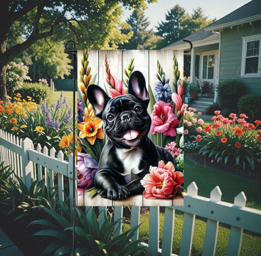 A beautiful black and white French Bulldog dog surrounded by gorgeous flowers.