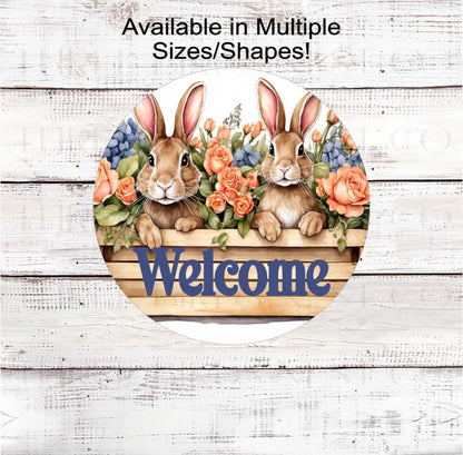 An adorable pair of Bunnies in a wood planter box surrounded by beautiful roses and hydrangeas.