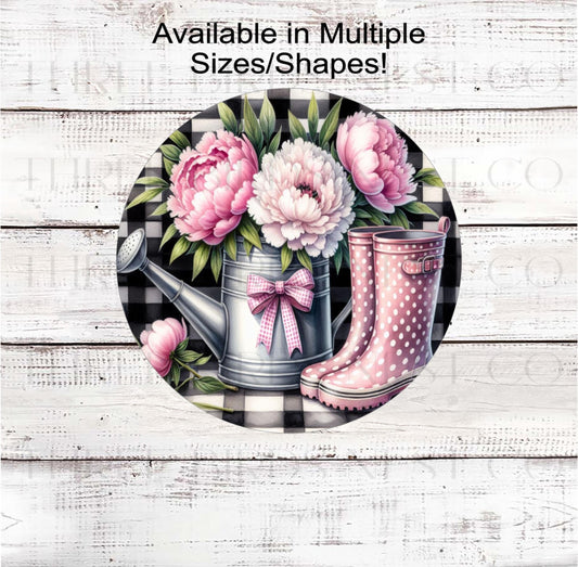 A beautiful watering can with pink Peonies and pink polka dot rain boots.