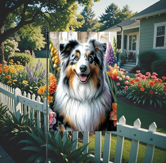 A beautiful Australian Shepherd dog surrounded by gorgeous flowers.