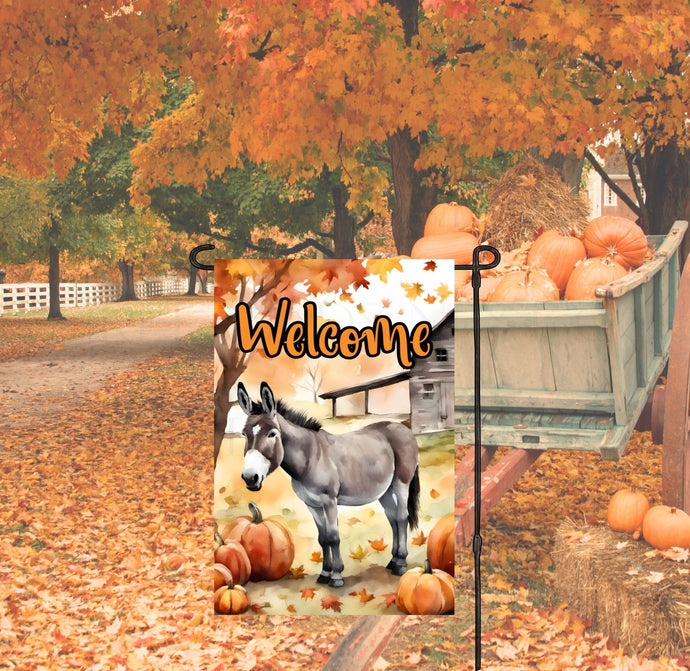 A Farmhouse Garden Flag for Fall with a Fall scene with pumpkins, a barn and a Donkey