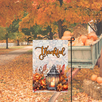 This beautiful Thankful Fall Garden Flag features a beautiful glowing lantern with candle that is surrounded by Fall flowers with a pumpkin