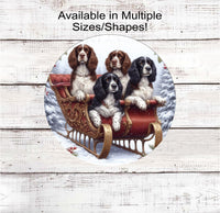 
              Four English Springer Spaniel Dogs sitting in a fancy Sleigh in a winter snowy setting
            