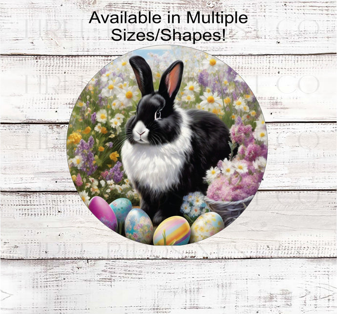 A beautiful black and white Easter Bunny surrounded by flowers and brightly colored Easter Eggs.