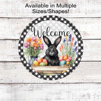 A beautiful black Easter Bunny surrounded by flowers and brightly colored Easter Eggs on a black buffalo plaid background.