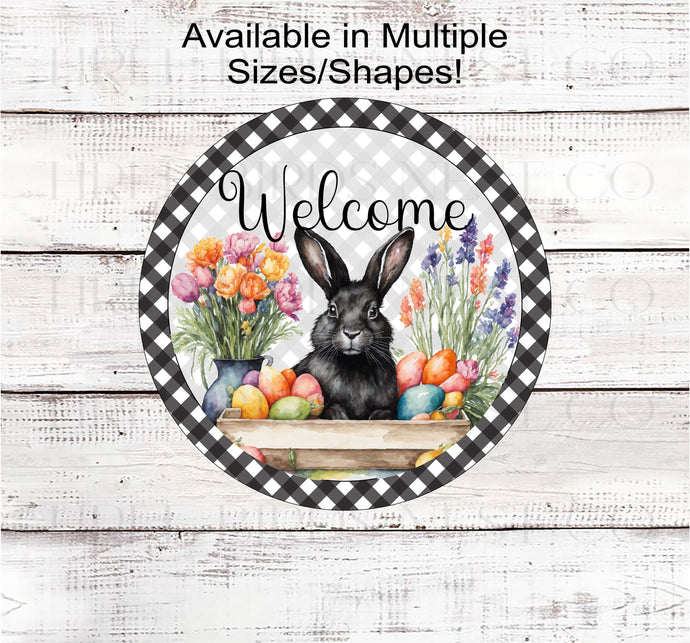 A beautiful black Easter Bunny surrounded by flowers and brightly colored Easter Eggs on a black buffalo plaid background.