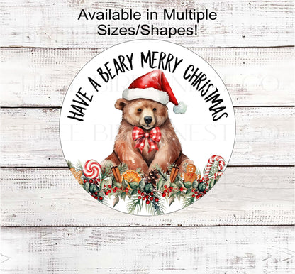 A brown Bear in a Santa Hat with a Gingerbread and greenery border.