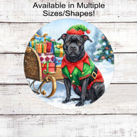 An adorable Black Pit Bull Dog dressed as a Christmas Elf.