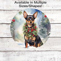 A Miniature Pinscher dog in a festive collar sitting in a Winter Wonderland.