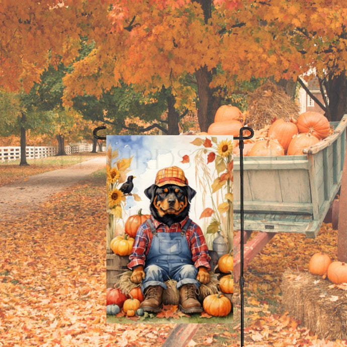 A Fall Garden Flag with a Rottweiler dressed up as a Scarecrow with pumpkins, sunflowers and a crow.
