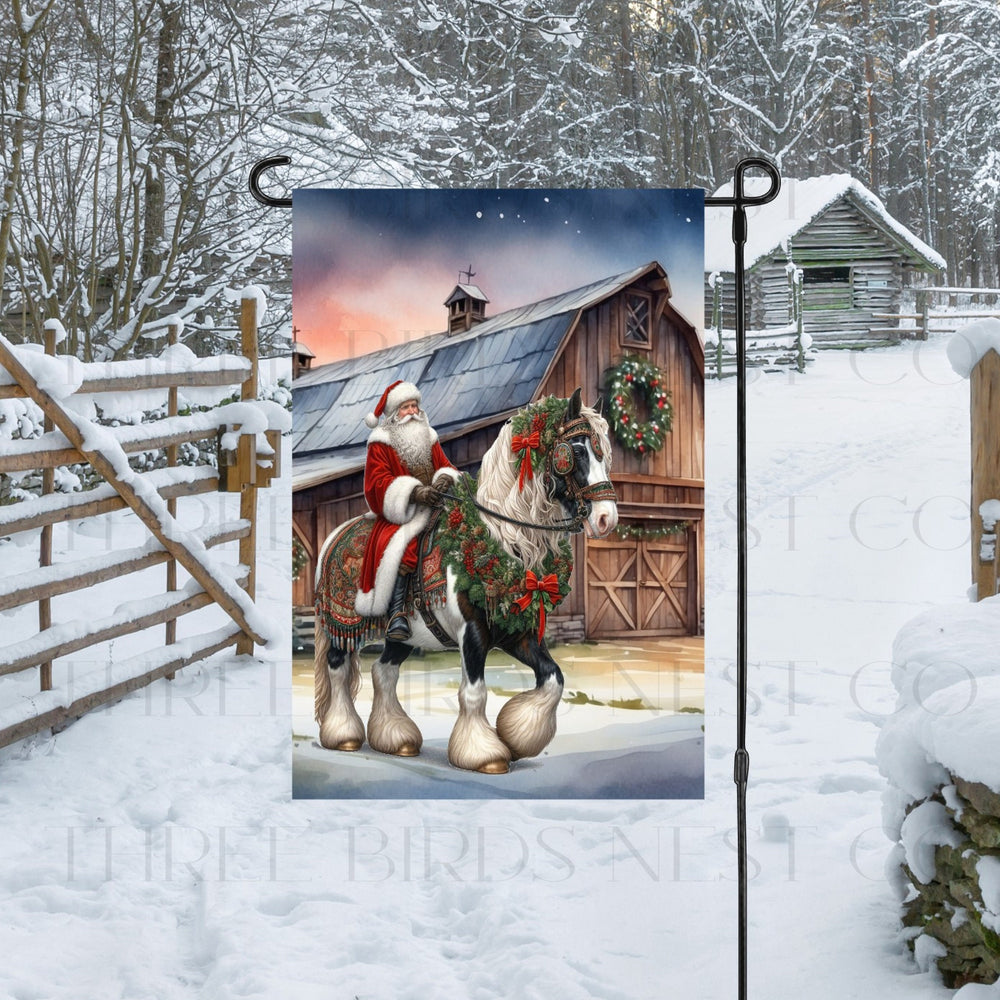 Santa Claus riding a Gypsy Vanner horse in front of a Christmas barn.