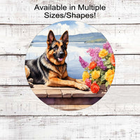 A beautiful German Shepherd dog on a dock with a flower pot overlooking a lake.