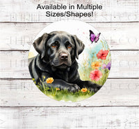 
              A black Labrador Retriever dog surrounded by beautiful flowers and butterflies.
            