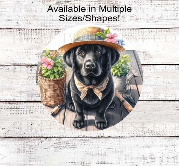 A black Labrador Retriever dog in a straw hat and ready to garden