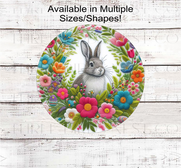 A grey Bunny Rabbit in the middle of a frame made of faux embroidered Spring flowers.