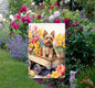 A beautiful Yorkshire Terrier Dog in a wooden cart full of Spring flowers.