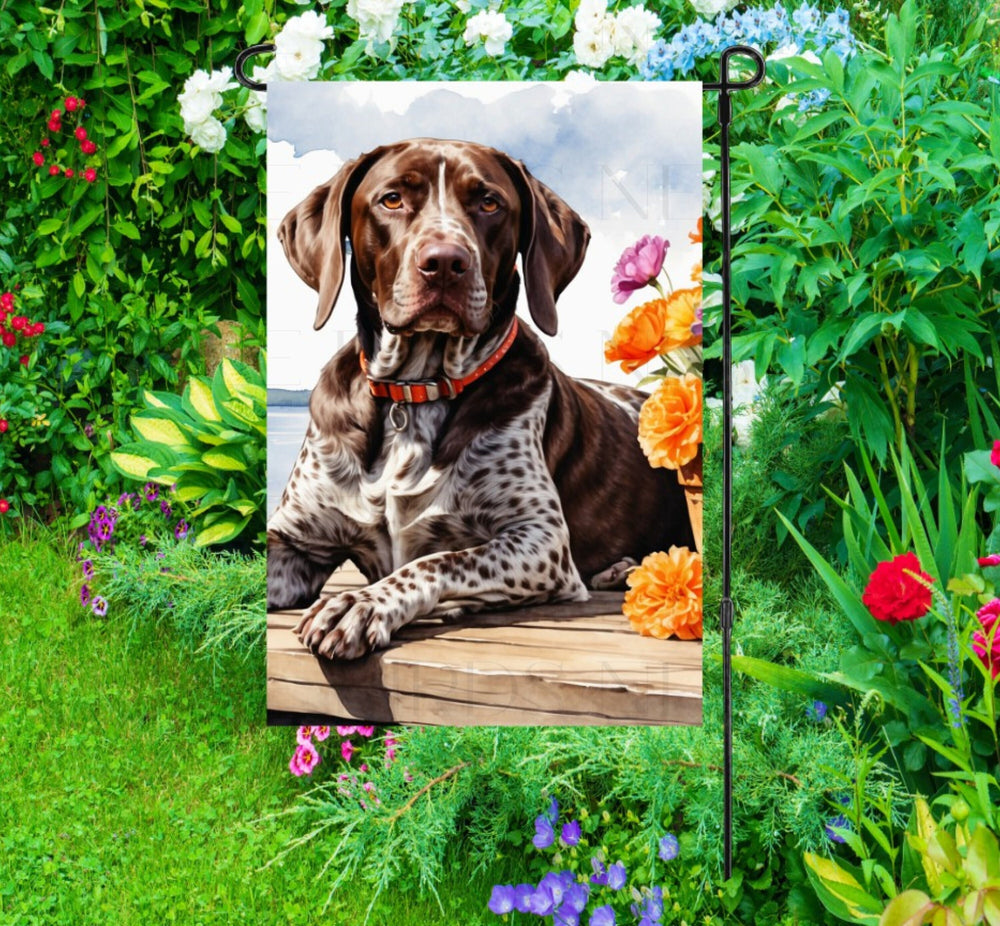 A beautiful German Shorthaired Pointer dog on a dock overlooking a Lake.