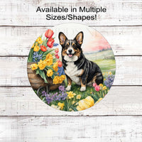 A tri-colored Corgi Dog surrounded by beautiful Spring flowers.