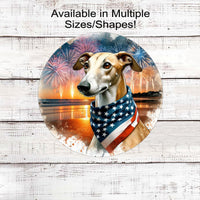 A beautiful Greyhound dog wearing an American Flag Bandanna on a Beach with Fireworks.